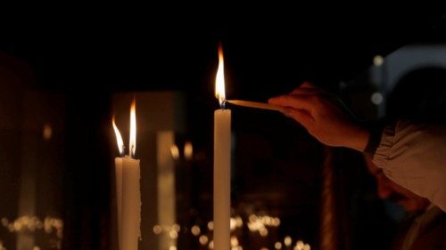 epa10339072 A Christian pilgrim lighting a candle at the  Church of the Nativity, in the West Bank ...