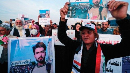 Iraqi demonstrators lift placards calling for the release of activist Haidar al-Zaidi, who was given ... Iraqi demonstrators lift placards calling for the release of activist Haidar al-Zaidi, who was given ...