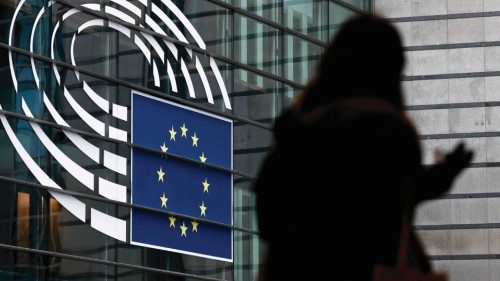 A woman walks near the entrance of the European Parliament in Brussels on December 9, 2022. - ...