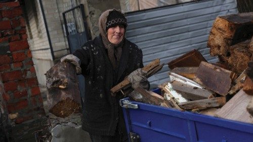 A woman loads fire wood, as Russia's attack on Ukraine continues, in the formerly Russian occupied ... A woman loads fire wood, as Russia's attack on Ukraine continues, in the formerly Russian occupied ...