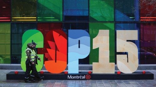 Police officers walk past a sign as they patrol outside the Palais de Congres, during the opening of ...