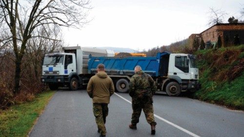 German officers serving in the peacekeeping mission in Kosovo (KFOR) inspect a road barricade set up ...