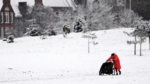 epaselect epa10361714 A woman pushes her child through a snow covered park in central London, ...