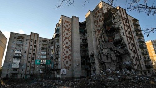 A photograph shows heavily damaged residential buildings following attacks in the town of Lyman, ...