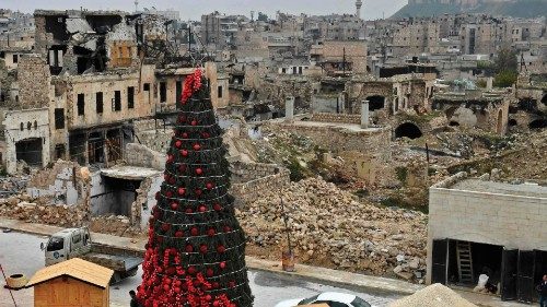 TOPSHOT - Workers set up a Christmas tree at al-Hatab square, one of the oldest in Syria's northern ...