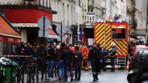 French police and firefighters secure a street after gunshots were fired killing two people and ...