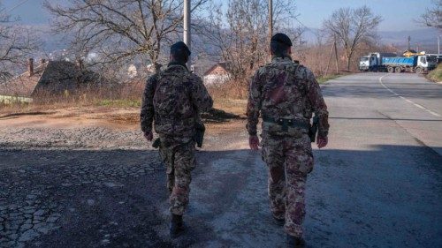 Italian soldiers serving in a NATO-led international peacekeeping mission in Kosovo patrol near a ...