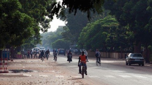 FILE PHOTO: People ride bicycles and motorcycles on a street in Ouagadougou, Burkina Faso, September ...