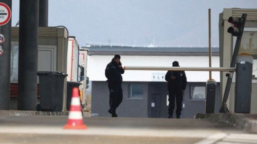Police officers keep guard at Merdare border crossing between Kosovo and Serbia which was closed by ...