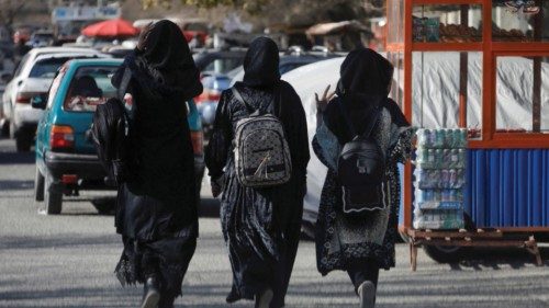 FILE PHOTO: Afghan female students walk near Kabul University in Kabul, Afghanistan, December 21, ...
