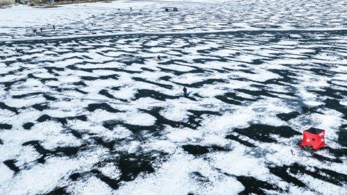 epa10380676 An aerial photo made with a drone shows people ice fishing on frozen Channel Lake in ...