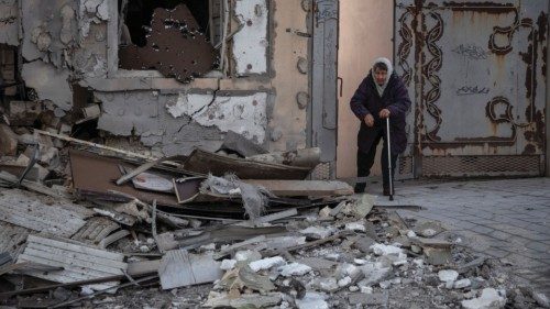 Local resident Klavdia, 82, stands near her house which was destroyed by a Russian military strike, ...