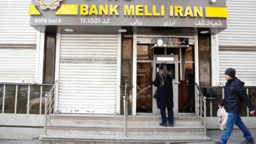 epa10381404 An Iranian woman uses an ATM machine of Iran's national bank branch 'Bank Melli' in ...