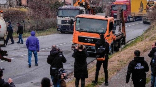 Journalists film as Kosovo Serbs remove trucks from a road barricade set up by ethnic Serbs in the ...