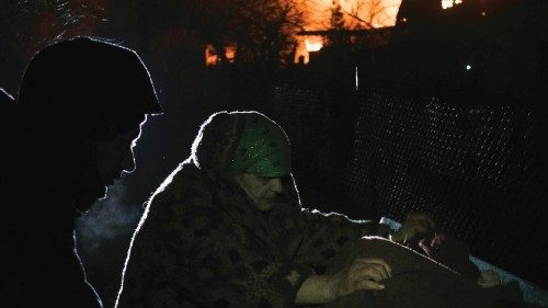 epa10386754 A local woman collects things near a burning building after Russian shelling in the ...