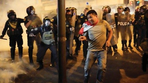 A protester reacts as police disperse protesters during a demonstration demanding the dissolution of ...