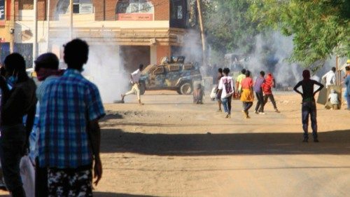 Sudanese anti-coup protesters run from tear gas fired by security forces as they protest in the ...