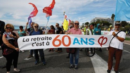 FILE PHOTO: Protestors hold a banner which reads 'Retirement is at 60' during a demonstration as ...