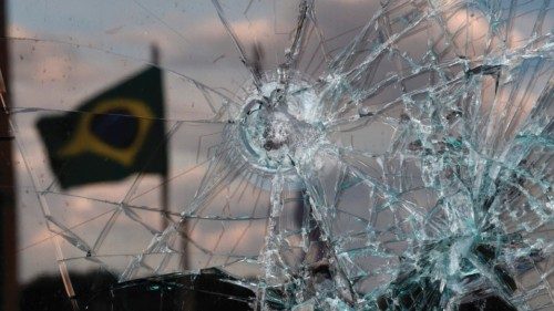 A Brazilian flag is reflected on a broken window of the Supreme Court building in Brasilia on ...