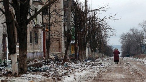 An elderly local resident walks on a street in the town of Siversk, Donetsk region on January 13, ...