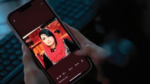 A woman looks at a picture of former Afghan lawmaker Mursal Nabizada on her mobile phone, who was ...