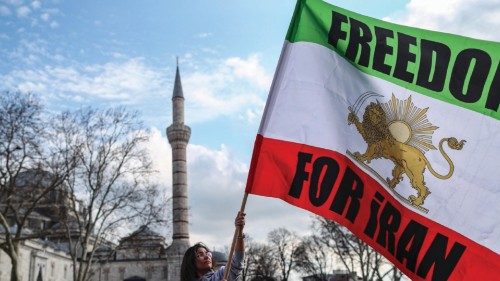 epa10407111 An Iranian woman hold a Iranian flag during a solidarity protest with the protests in ...