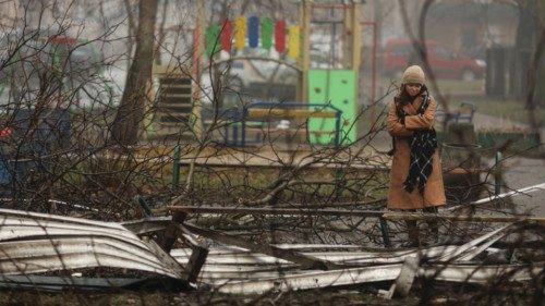 A relative looks at the site of a helicopter crash, amid Russia's attack on Ukraine, in the town of ...