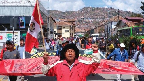 A man holds a Peruvian flag as he takes part in a demonstration before heading to Lima, to gather ...