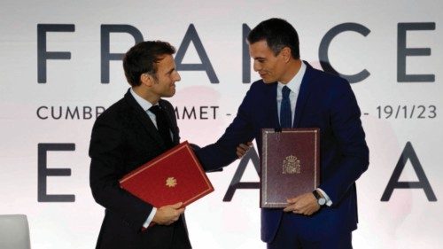 Spain's Prime Minister Pedro Sanchez (R) and France's President Emmanuel Macron shake hands after ...