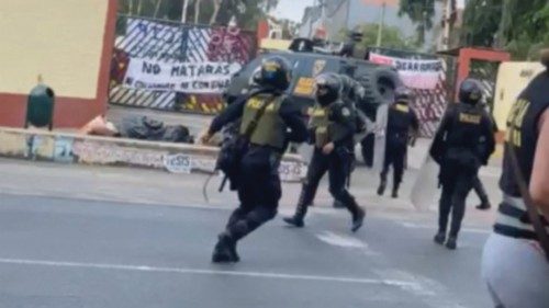 Police officers walk to the University San Marcos, in Lima, Peru January 21, 2023, in this screen ...