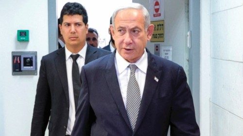 Israeli Prime Minister Benjamin Netanyahu (front) arrives for a hearing at the Magistrate's Court in ...