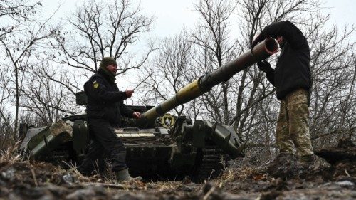 Ukrainian service members check a tank barrel during offensive and assault drills, amid Russia's ...