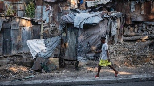 epa10401871 A man walks in downtown Port-au-Prince, Haiti, 12 January 2023. Haiti marks the 13th ...
