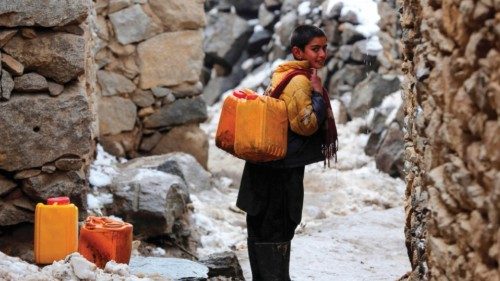 In this photograph taken on January 23, 2023, an Afghan boy carries drinking water canisters after ...