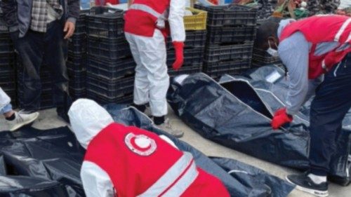 Libyan Red Crescent workers put the body of a migrant, who died after their boat capsized, in a bag, ...