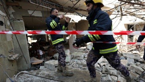 epa10430777 Palestinian rescuers work at the site of a damaged building following an Israeli forces ...