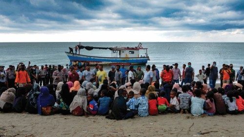 (FILES) In this file photograph taken on June 25, 2020, evacuated Rohingya from Myanmar sit on the ...