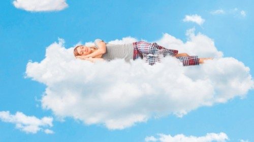 Tranquil scene of a young woman dreaming and sleeping on a cloud up in the sky Tranquil scene of a young woman dreaming and sleeping on a cloud up in the sky
