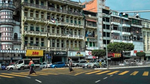 Pedestrians cross an almost empty street during a 'silent strike' to protest and mark the second ...