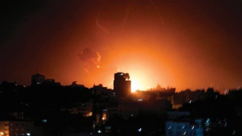 TOPSHOT - Fire and smoke rise above buildings in Gaza City as Israel launched air strikes on the ...