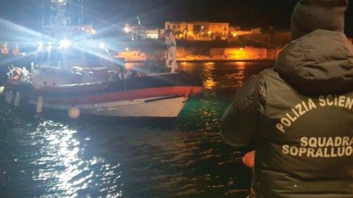 Police officers on the quay of the port wait for the boat containing the bodies of 8 migrants in ...