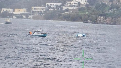 A fishing boat approaches a half-sunken inflatable boat that was carrying migrants off the island of ... A fishing boat approaches a half-sunken inflatable boat that was carrying migrants off the island of ...