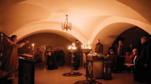 Orthodox Christians attend the Sunday prayer at the basement of the Church of All Saints as sounds ... Orthodox Christians attend the Sunday prayer at the basement of the Church of All Saints as sounds ...