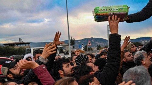 TOPSHOT - Earthquake survivors gather to collect supplies at a diaper distribution in Hatay on ...