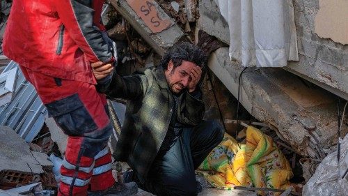 TOPSHOT - A man pleads to a rescue worker to save his brother in Hatay, southeastern Turkey, on ...