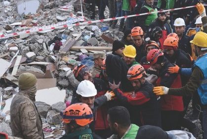 Arda Oktay is carried to an ambulance after being rescued alive from rubble in the aftermath of a ...