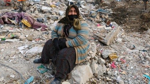 A woman reacts at the site of a collapsed building as the search for survivors continues, in the ...