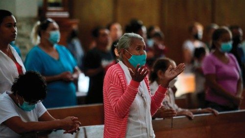 A woman prays during a mass by Nicaraguan Cardinal Leopoldo Brenes (out of frame) at the ...