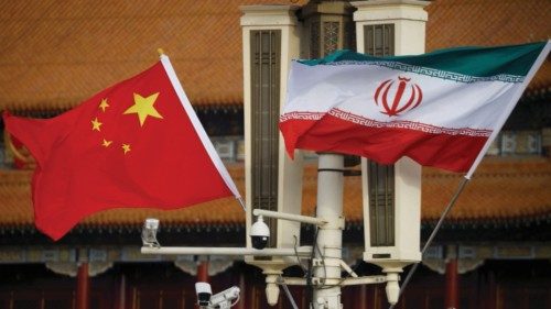 The national flags of China and Iran fly in Tiananmen Square during Iranian President Ebrahim ...