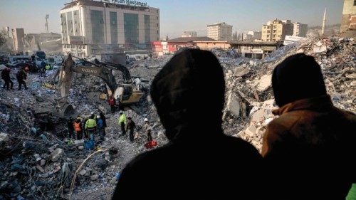 TOPSHOT - People stand hoping for news of their relatives as search and rescue teams search the ... TOPSHOT - People stand hoping for news of their relatives as search and rescue teams search the ...